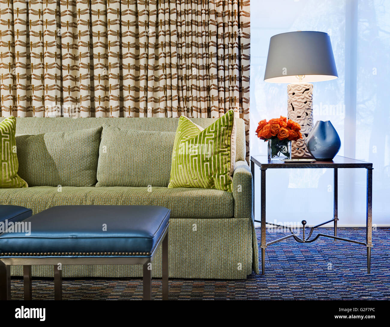 Green Sofa and Pillows next to Glass End Table, Detail Stock Photo