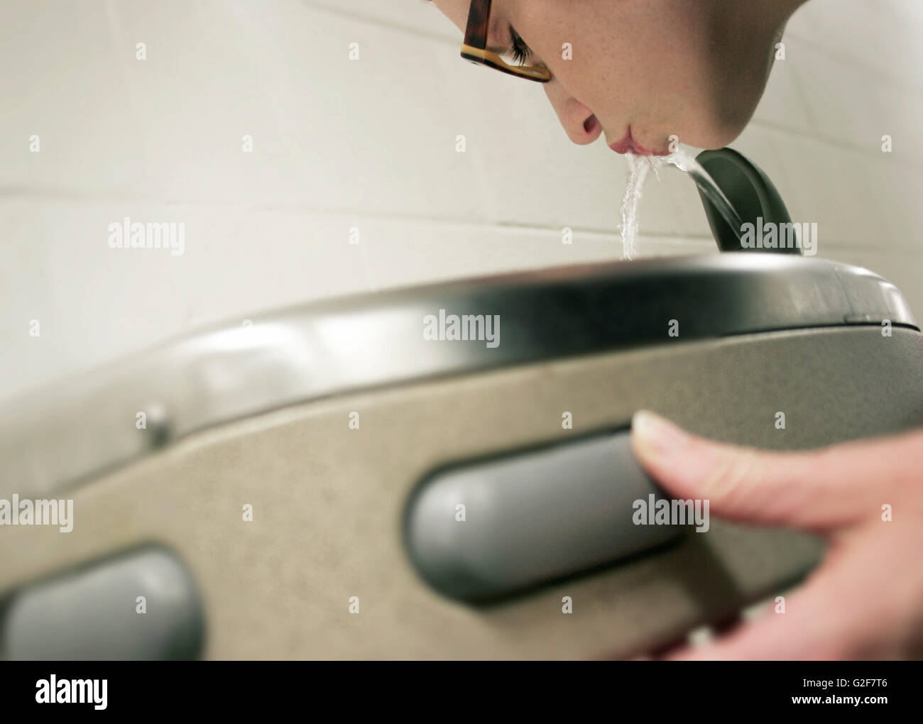 Woman Drinking from Water Fountain Stock Photo - Alamy