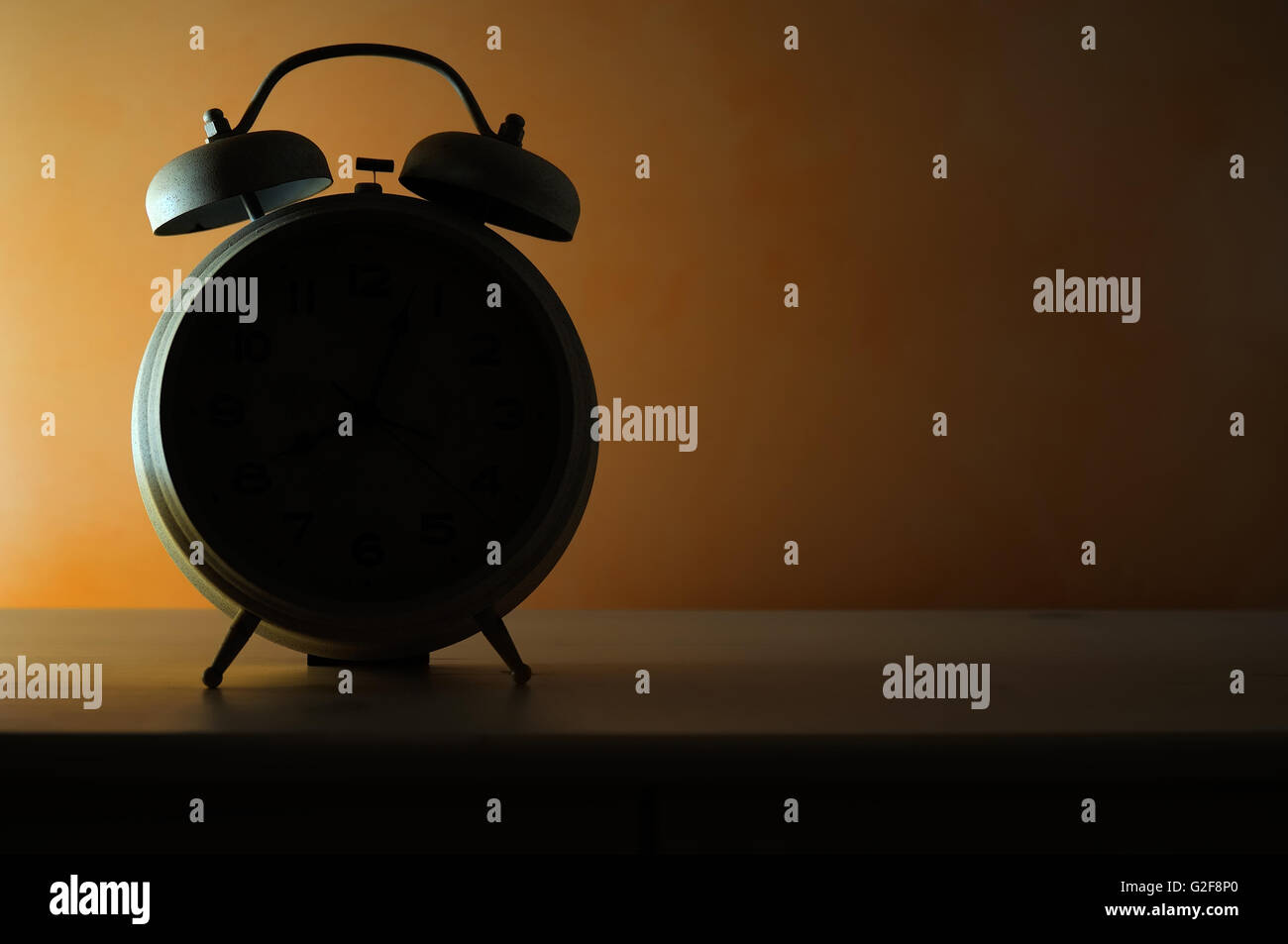 bedside vintage alarm clock in backlit Stock Photo Alamy