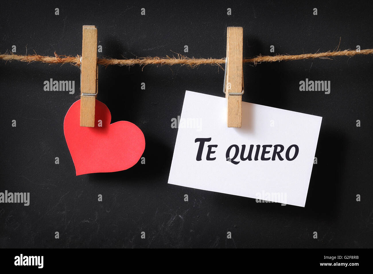 heart with te quiero poster hanging with blackboard background Stock Photo