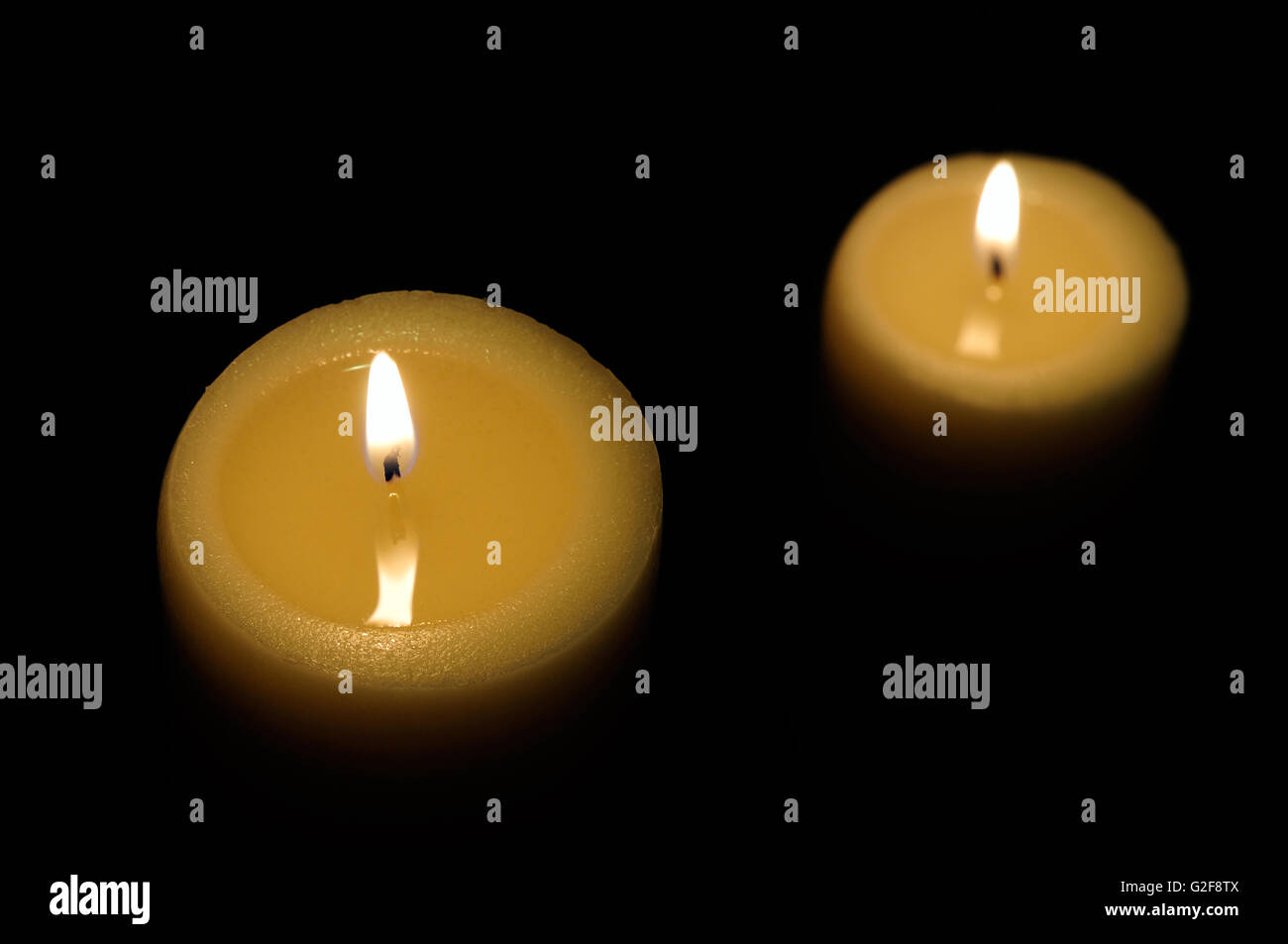 two candles lit with dark background top view Stock Photo Alamy