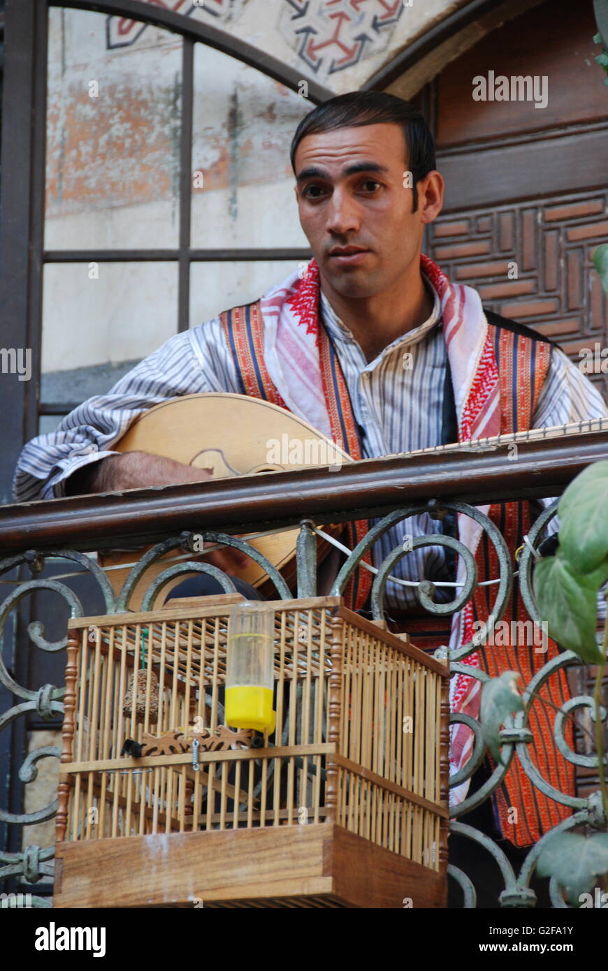 Damascus - Beit Jabri Restaurant, Man Playing Zither With Bird Cage Stock Photo