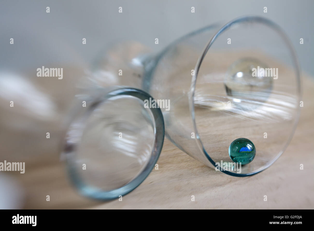 Glasses lying on table with small glass marbles Stock Photo - Alamy
