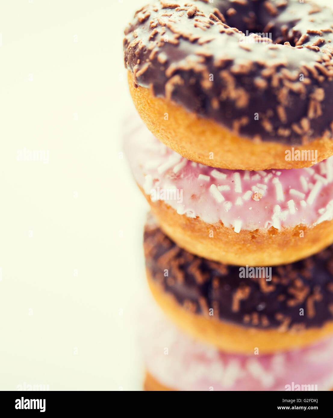 close up of glazed donuts pile over white Stock Photo - Alamy
