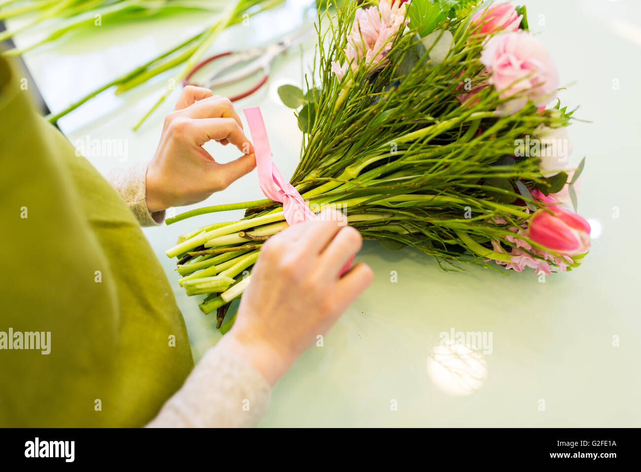 close up of woman making bunch at flower shop Stock Photo - Alamy