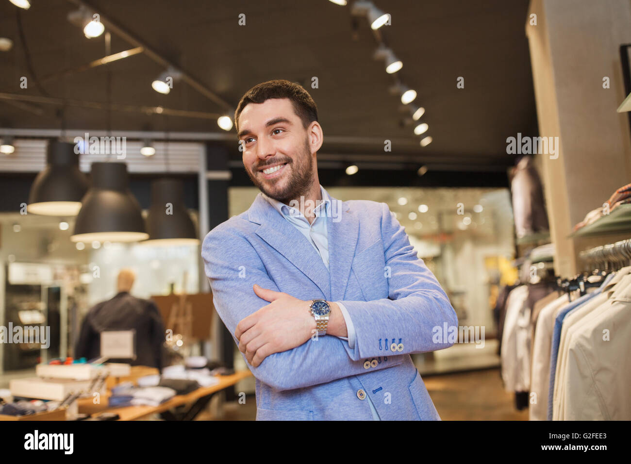 happy young man in jacket at clothing store Stock Photo - Alamy