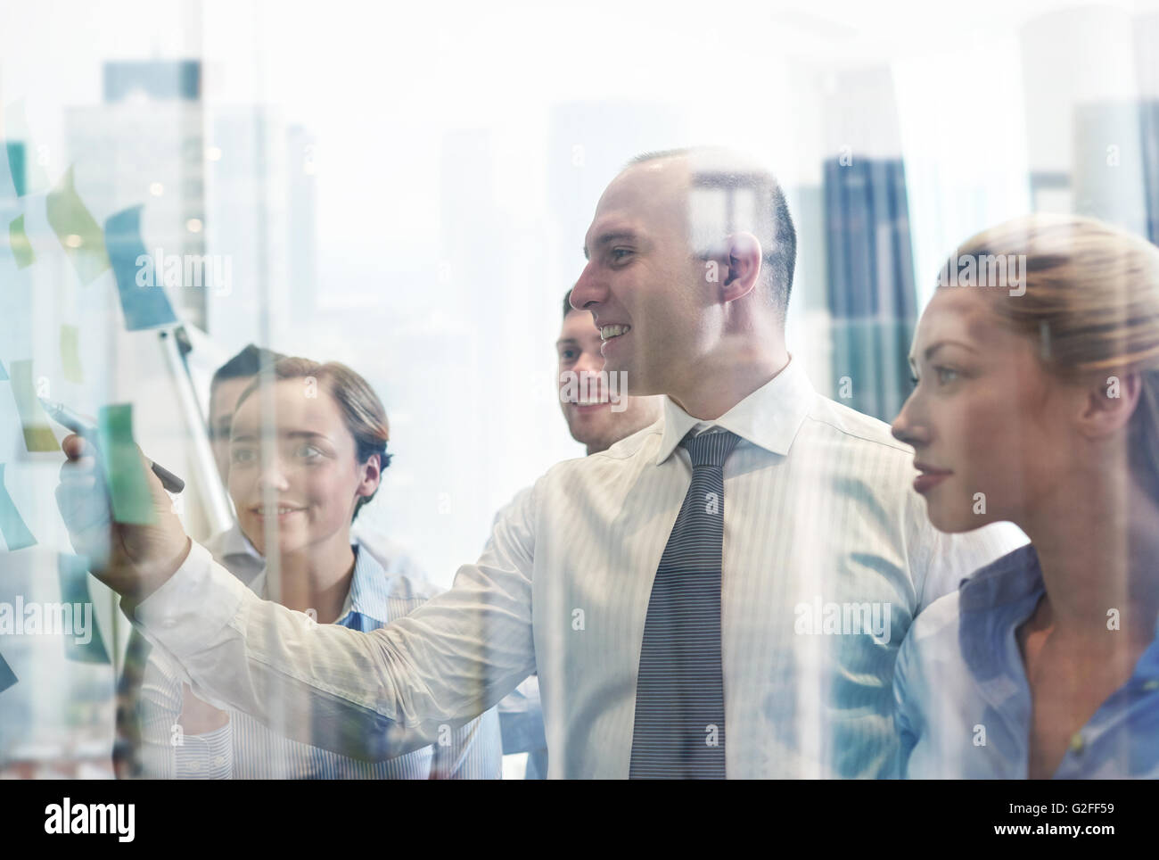 smiling business people with marker and stickers Stock Photo - Alamy