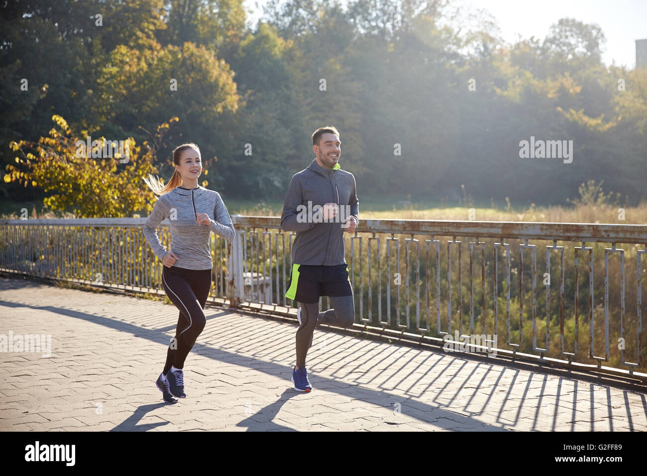 happy couple running outdoors Stock Photo - Alamy