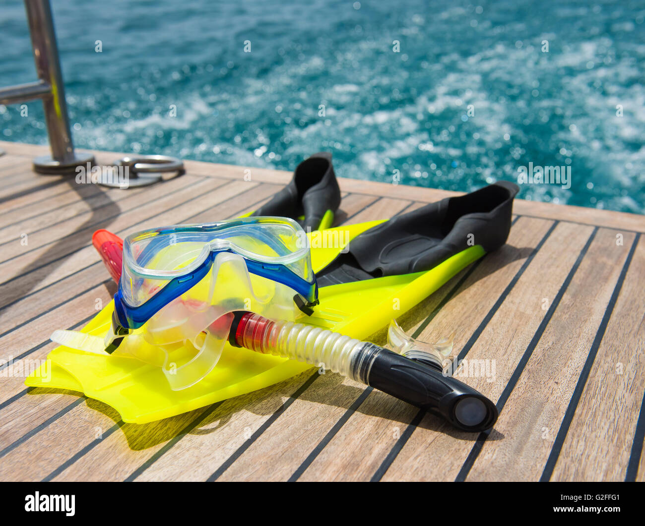 Snorkeling equipment on the wooden deck of a private luxury motor yacht traveling on tropical ocean Stock Photo