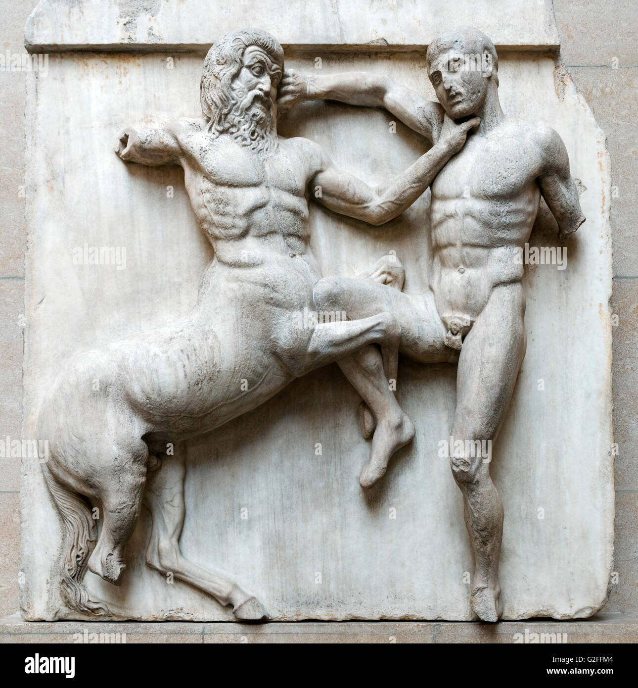 Marble metope from the south side of the Parthenon, showing the battle between Centaurs and Lapiths at the marriage-feast of Peirithoos. The Parthenon Sculptures or 'Elgin Marbles', Ancient Greece and Rome Galleries, British Museum, Bloomsbury, London, England, UK Stock Photo