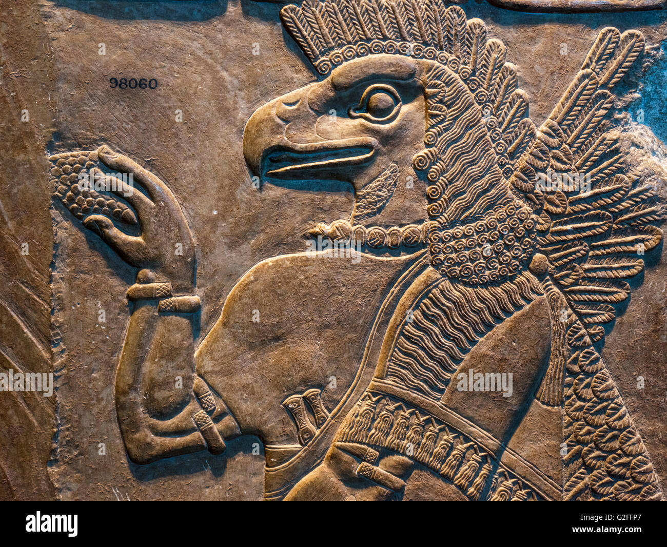 Detail of a carved relief of an eagle-headed protective spirit, c.865-860 BC from the Palace at Nimrud, Assyrian Gallery, British Museum, Bloomsbury, London, England, UK Stock Photo