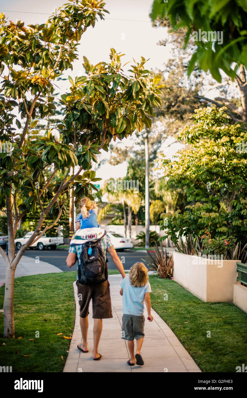 Father Walking with Two Children on Sidewalk, Rear View Stock Photo - Alamy