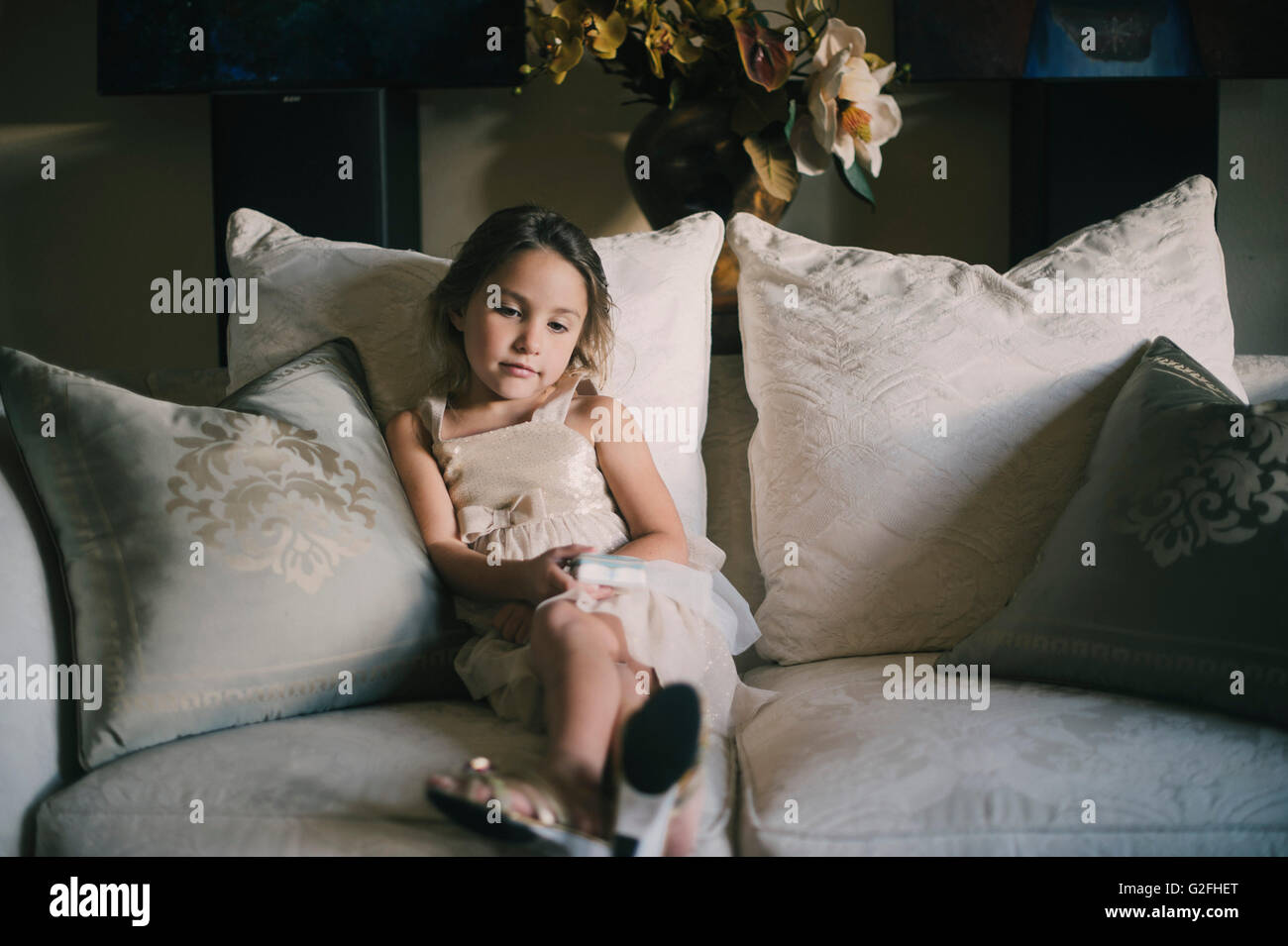 Portrait of Young Girl Sitting on Sofa Stock Photo - Alamy