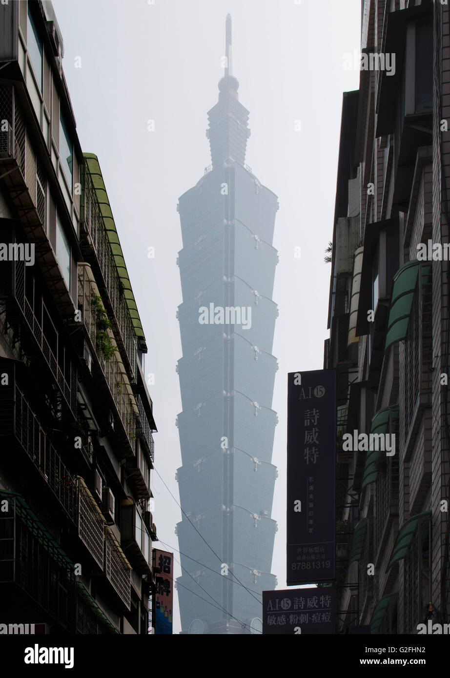 Taipei 101 Tower Viewed between Buildings on Narrow Street, Taipei, Taiwan Stock Photo