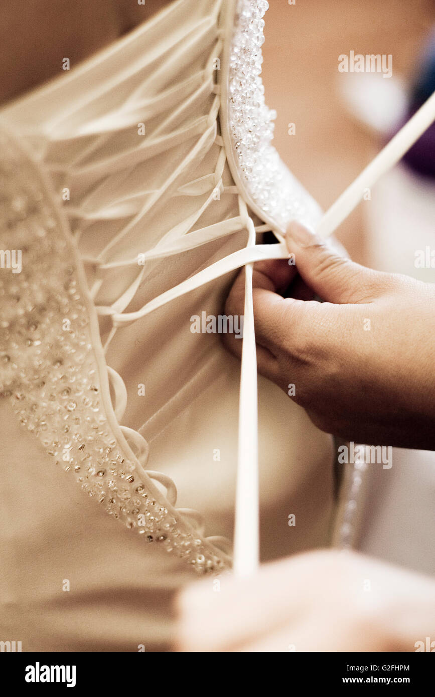 Lacing Up the Back of a Wedding Dress Stock Photo Alamy