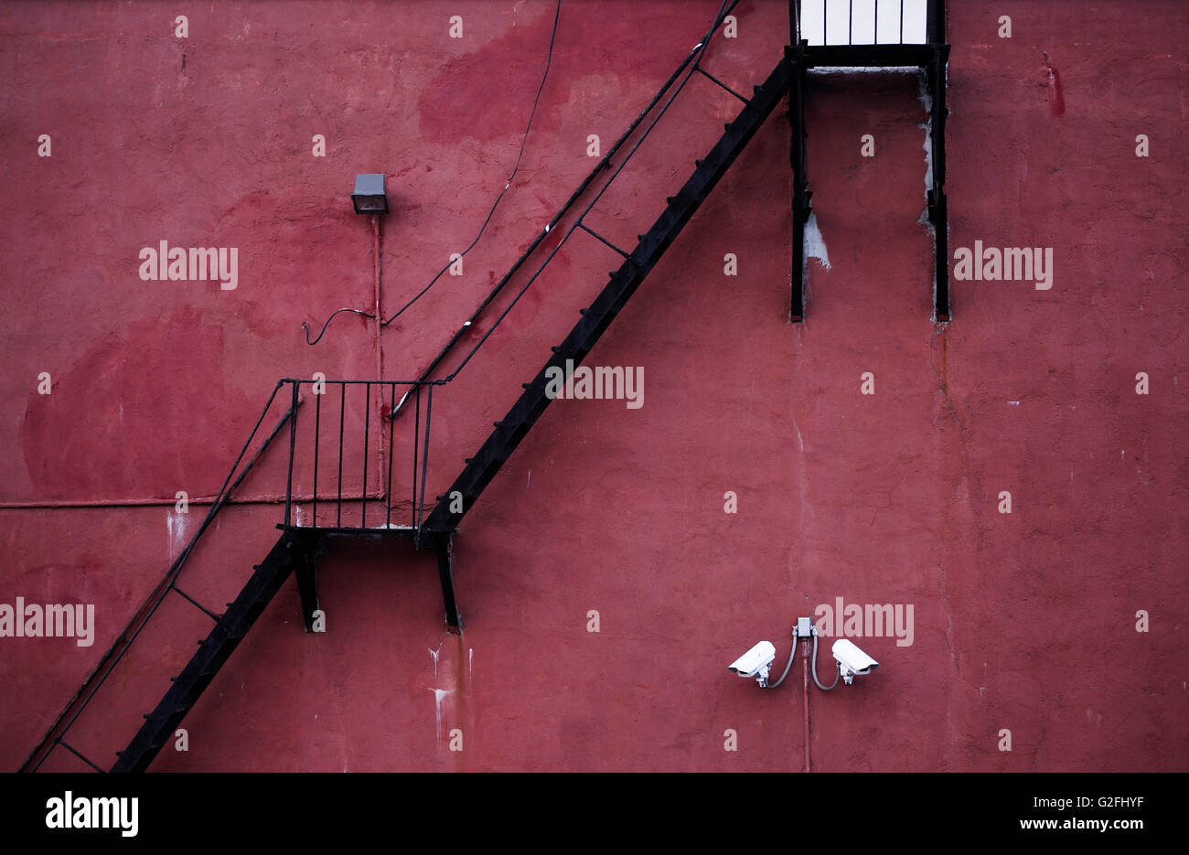 Exterior Staircase Against Red Wall Stock Photo