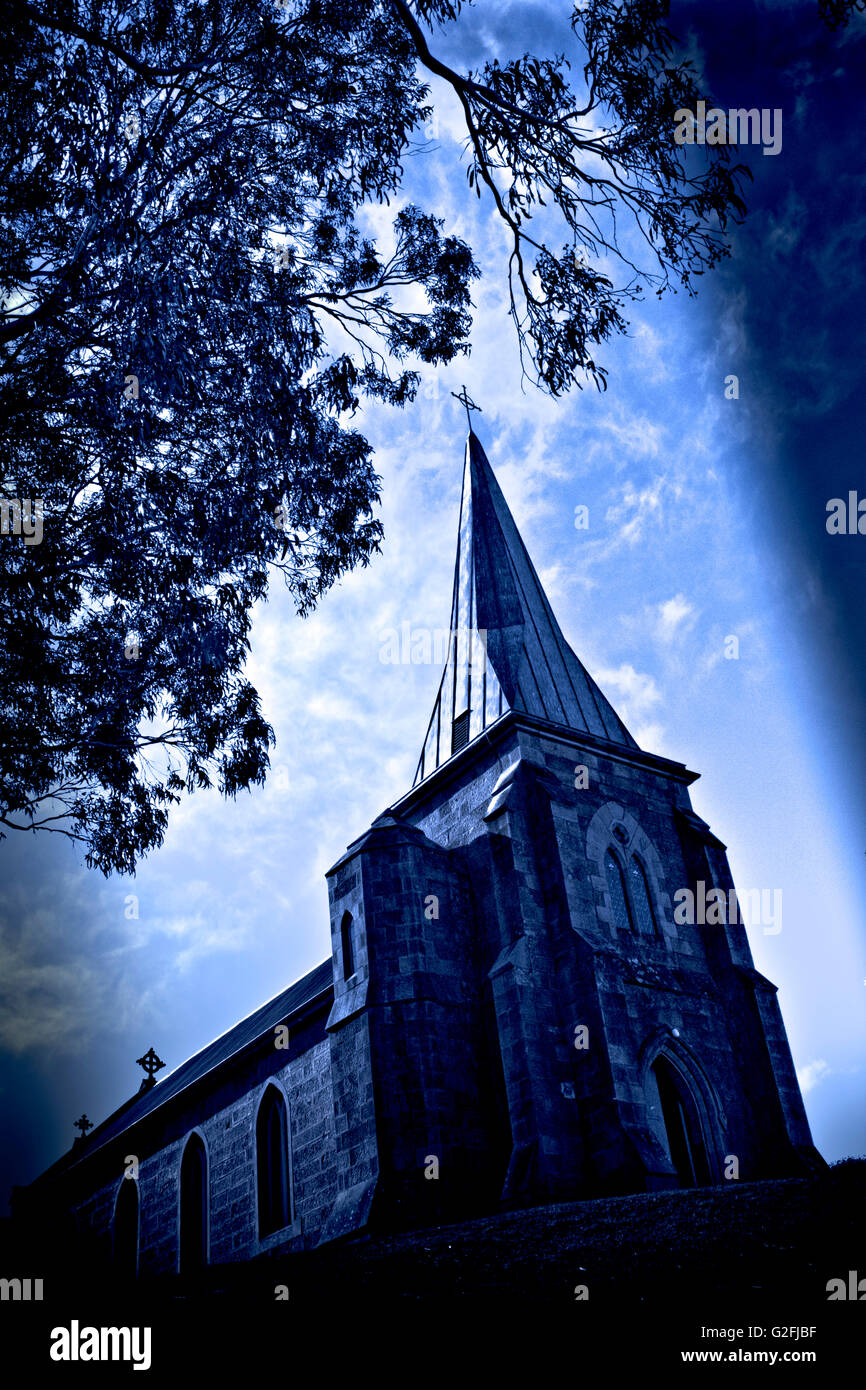 Church with Spire Against Blue Sky, Low Angle View Stock Photo