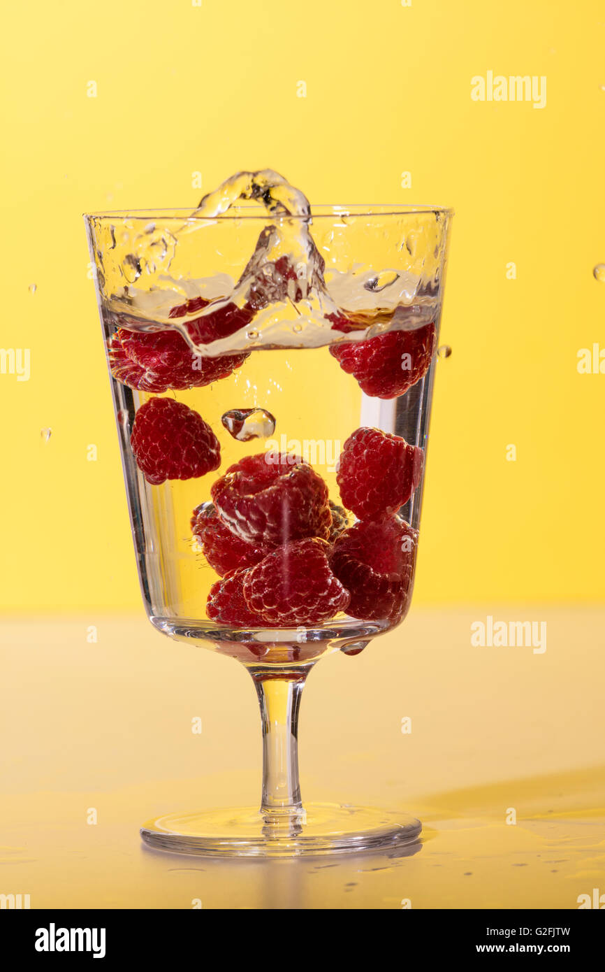 Glass of Fresh water with raspberries Stock Photo