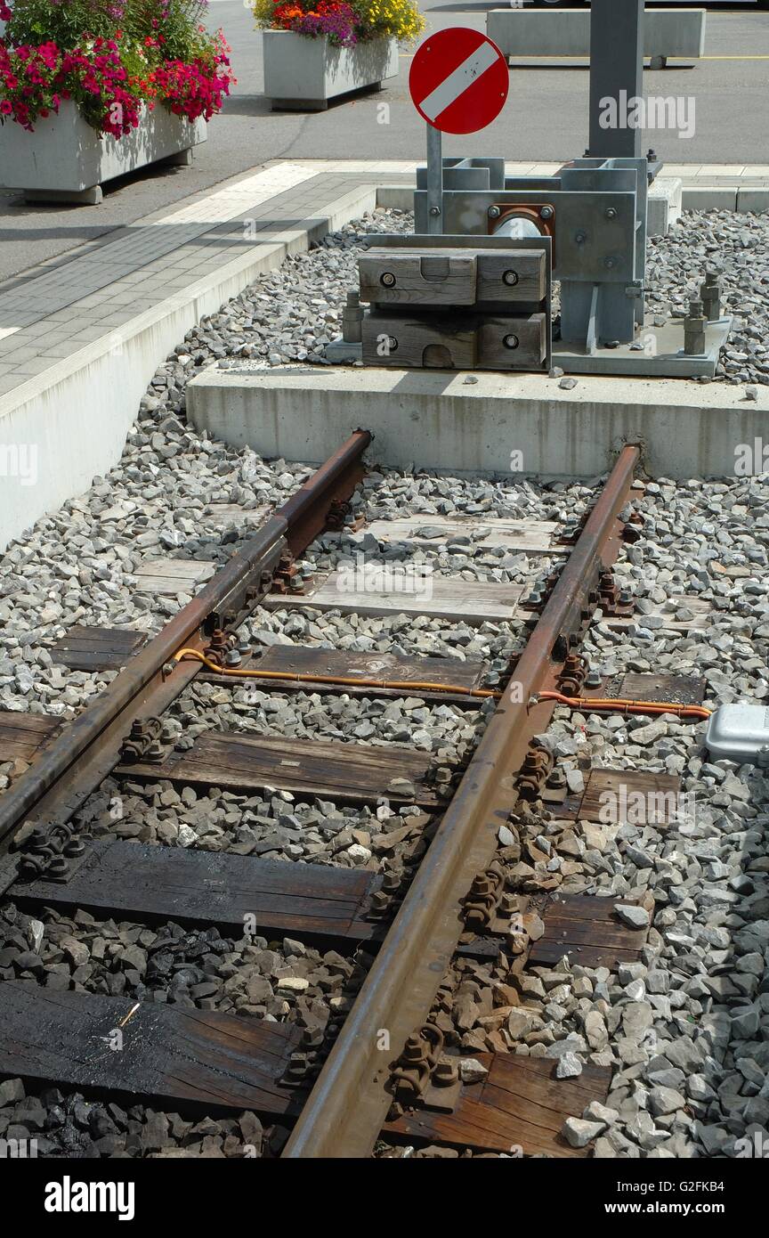 Modern buffer stop at the end of railway tracks on railway station. Stock Photo