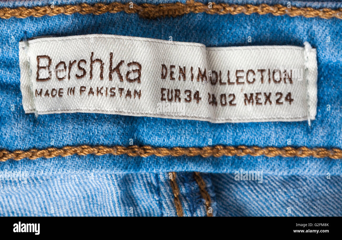 label in Bershka denim collection jeans trousers made in Pakistan - sold in the UK United Kingdom, Great Britain Stock Photo
