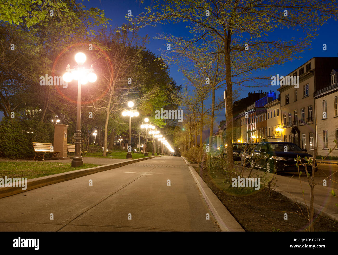 street lamps lighting up sidewalk in old Quebec City at night with