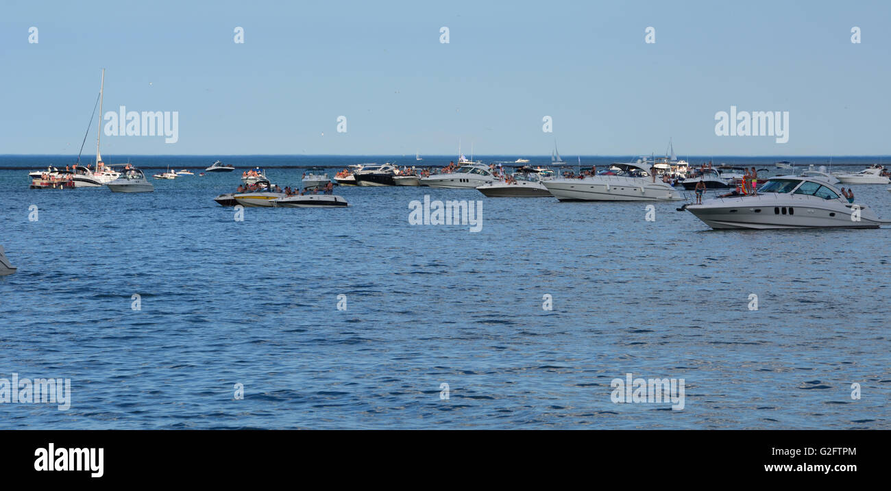 Party boats moored off of Milton Olive Park in 'the Playpen' a protected breakwall on Chicago's lake front during the Memorial Day weekend. Stock Photo