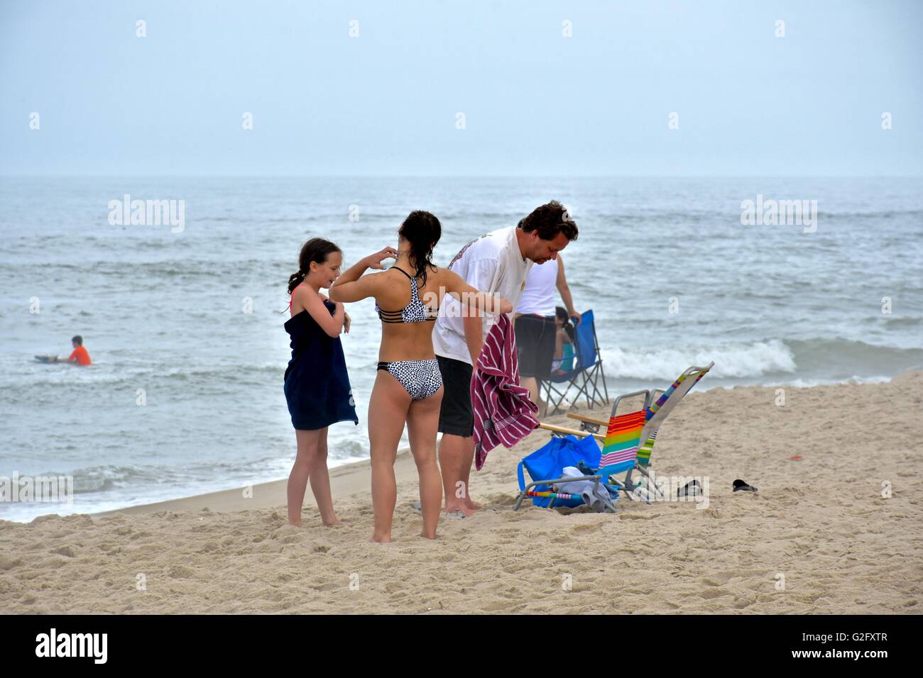 People enjoying a relaxing day on the beach with friends and family Stock Photo