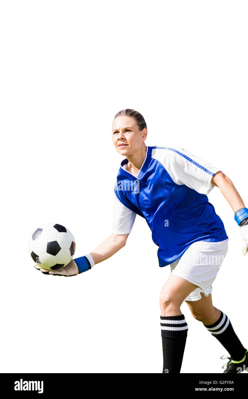 Woman goalkeeper throwing again the ball Stock Photo