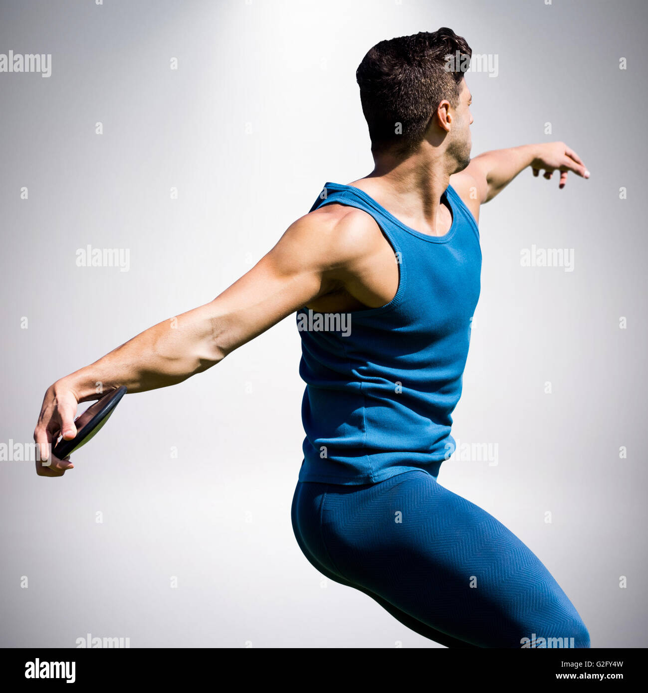 Composite image of side view of man throwing discus Stock Photo