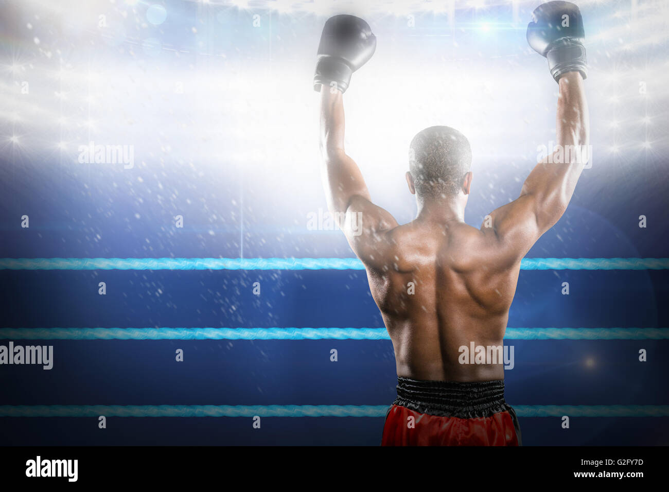 Composite image of boxer posing after victory Stock Photo