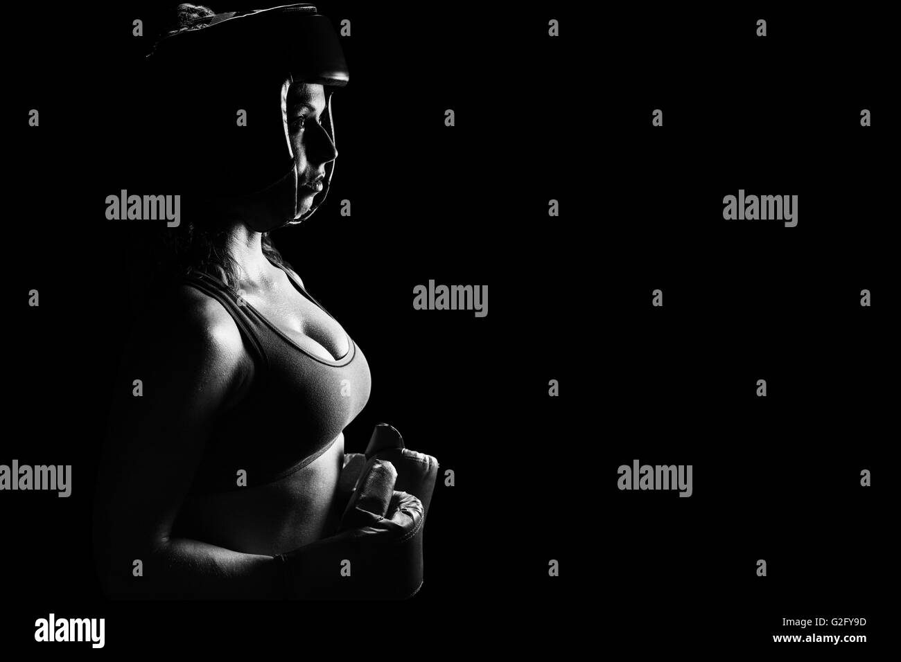 Composite image of side view of female boxer with headgear and gloves Stock Photo