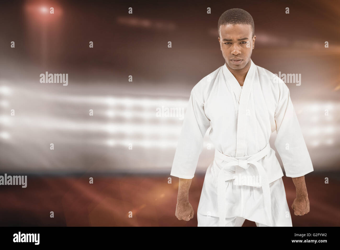 Composite image of front view of karate fighter meditating Stock Photo