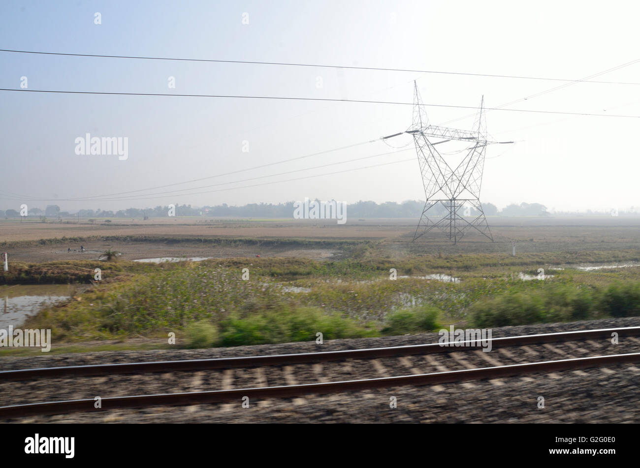 Indian countryside as viewed from the footboard of a running train