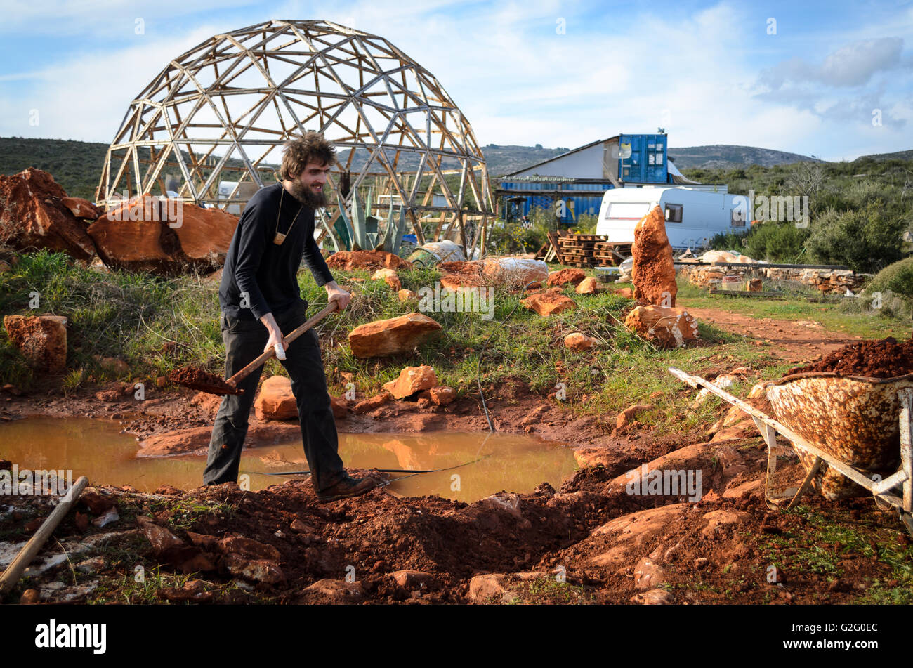 Digging a hole in the mud – eco farm Stock Photo