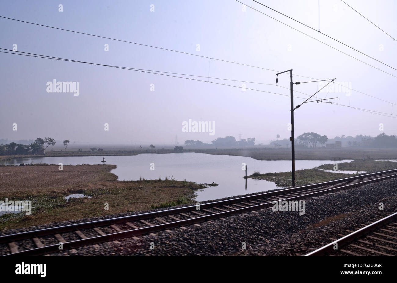 Indian countryside as viewed from the footboard of a running train