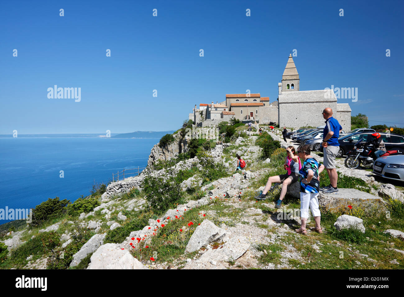 A group of tourists on their visit to the Lubenice town on the hilly Island of Cres Stock Photo