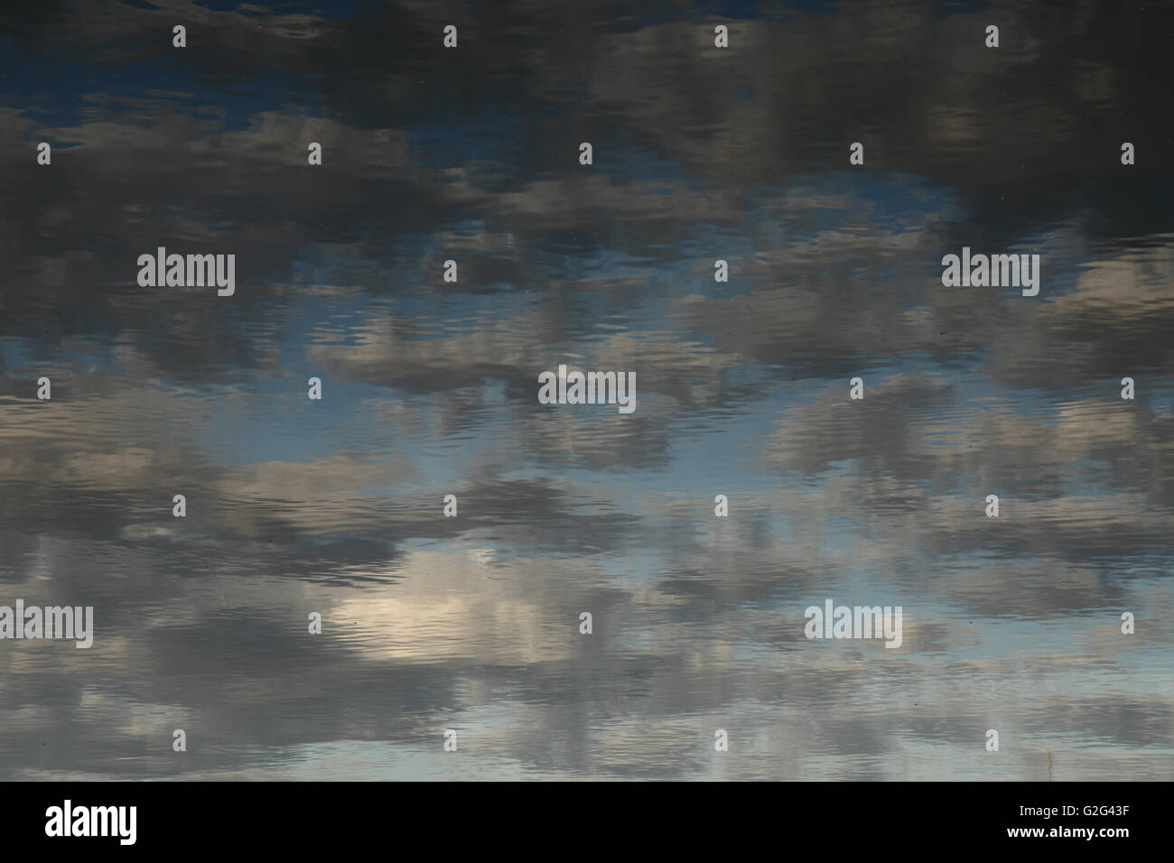 Reflection of Blue Sky and Clouds on Water Stock Photo - Alamy