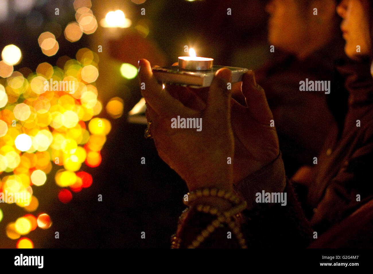Woman Holding Candle Offering at Kagyu Monlam, Bodhgaya, India Stock
