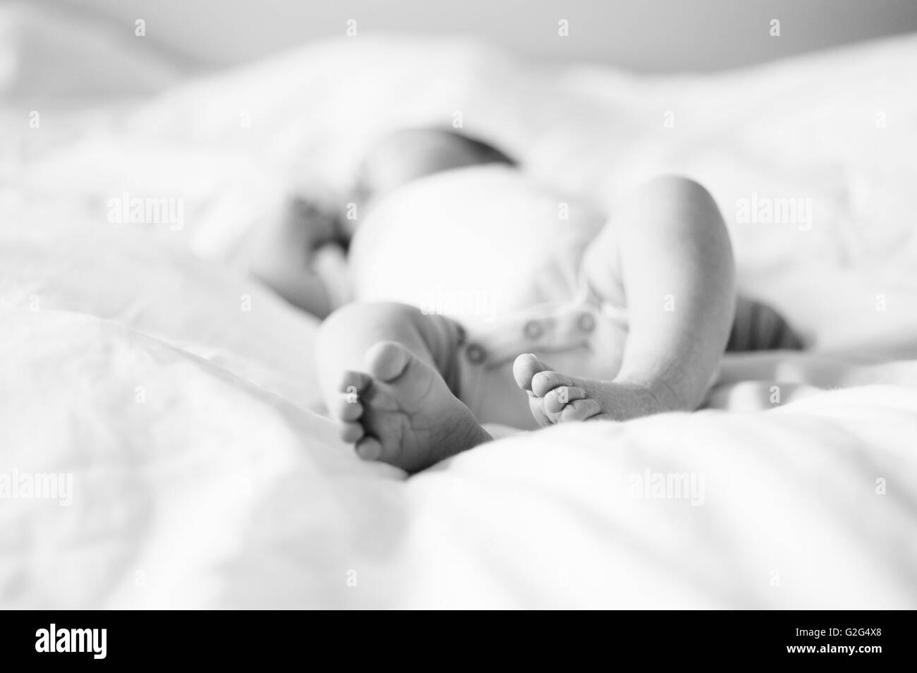 Newborn Baby in Onesie Sleeping on Bed Stock Photo Alamy