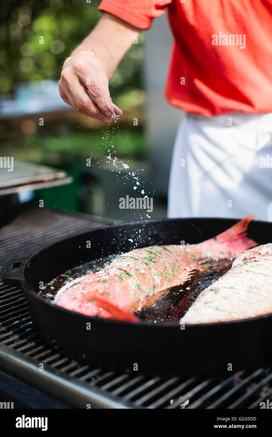Fish in Cast Iron Pan Being Cooked on Grill Stock Photo Alamy
