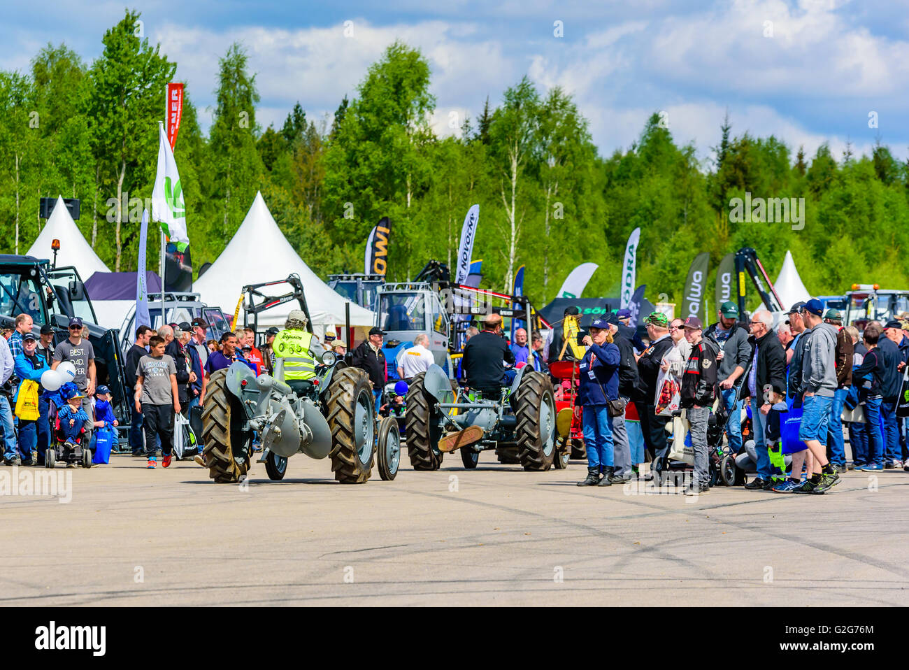 Emmaboda, Sweden - May 14, 2016: Forest and tractor (Skog och traktor) fair. Vintage classic tractors on parade. Interested crow Stock Photo