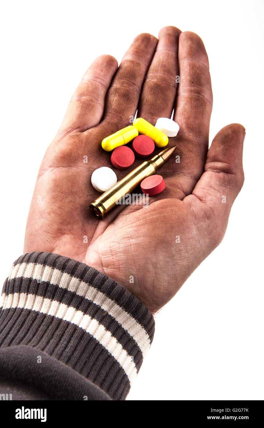 dirty human hand holding pills and bullet isolated on white background Stock Photo