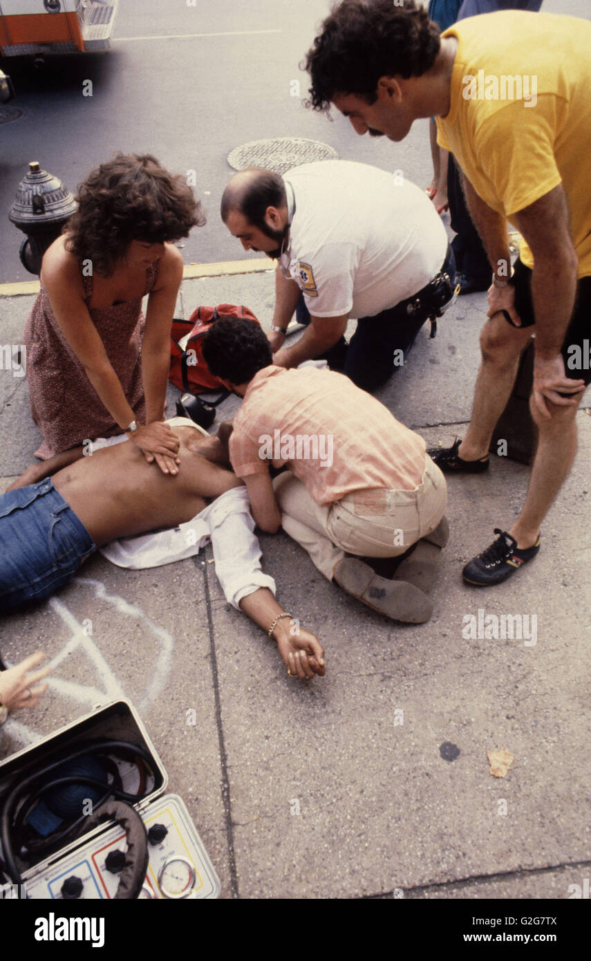 Passersby and paramedics perform cardiopulmonary resuscitation (CPR) on a pedestrian shot pistol at St. Marks and Third Avenue, Stock Photo