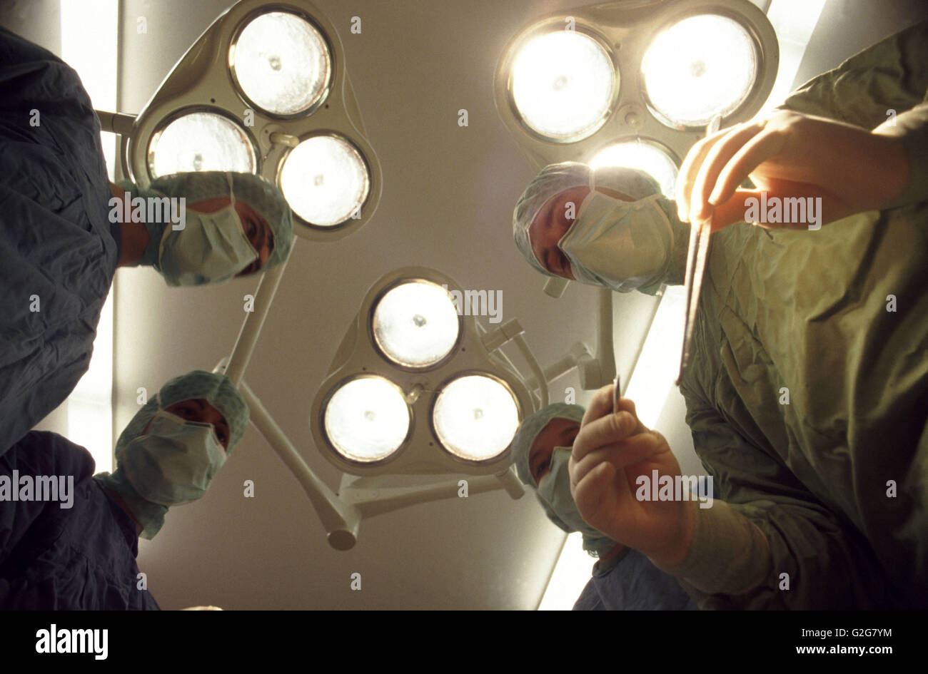 Doctors wearing surgical masks prepare for surgery in the OR, or operating room Stock Photo Alamy