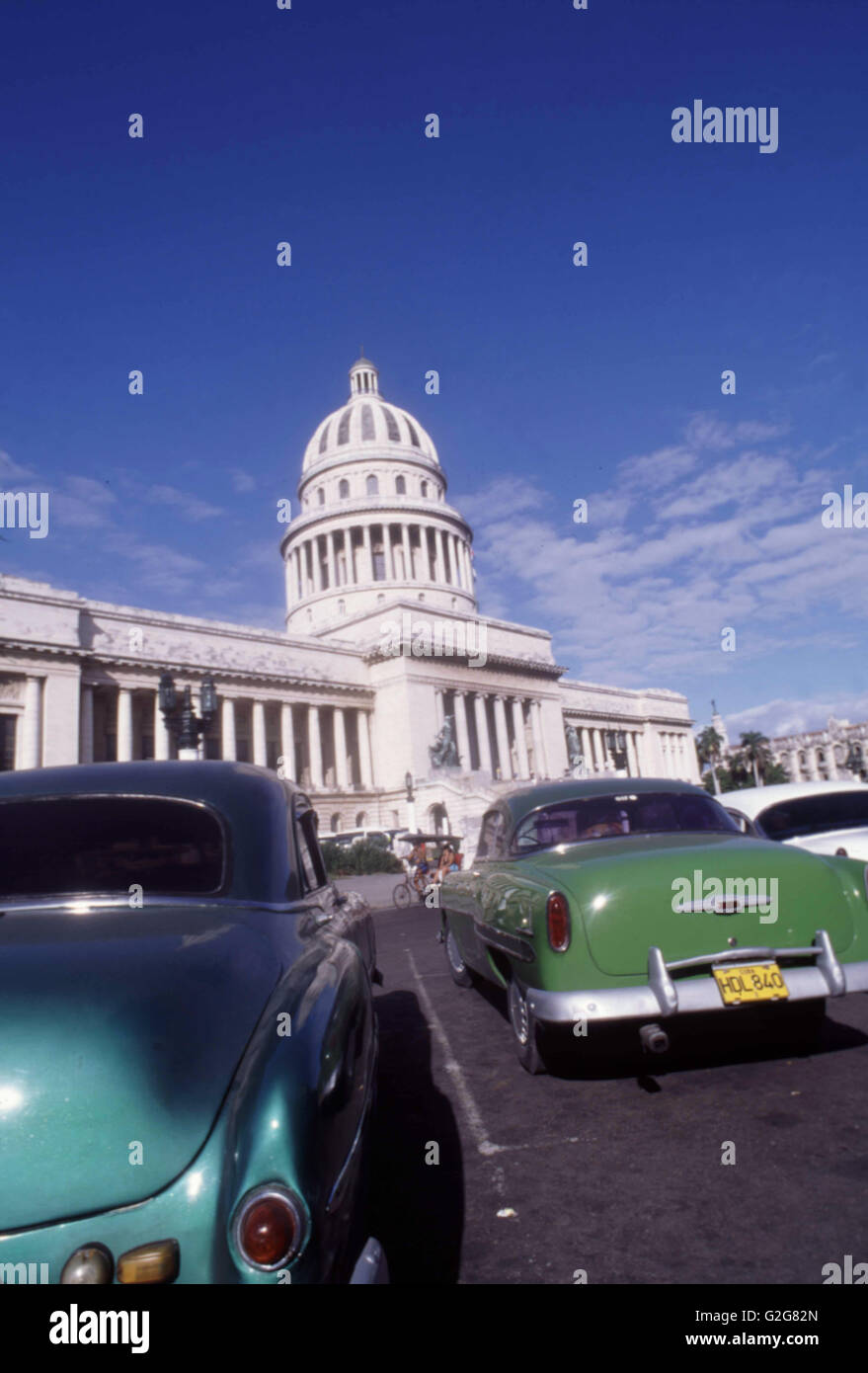 American Classic Cars (1953 Chevrolet Bel Air in Green, Pontiac in Turquoise) in front of the Capital Building in Havana, Cuba Stock Photo