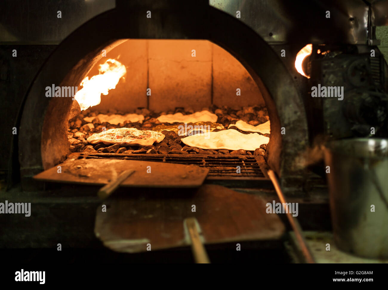 Old style middle east stone oven with flat bread with different spices