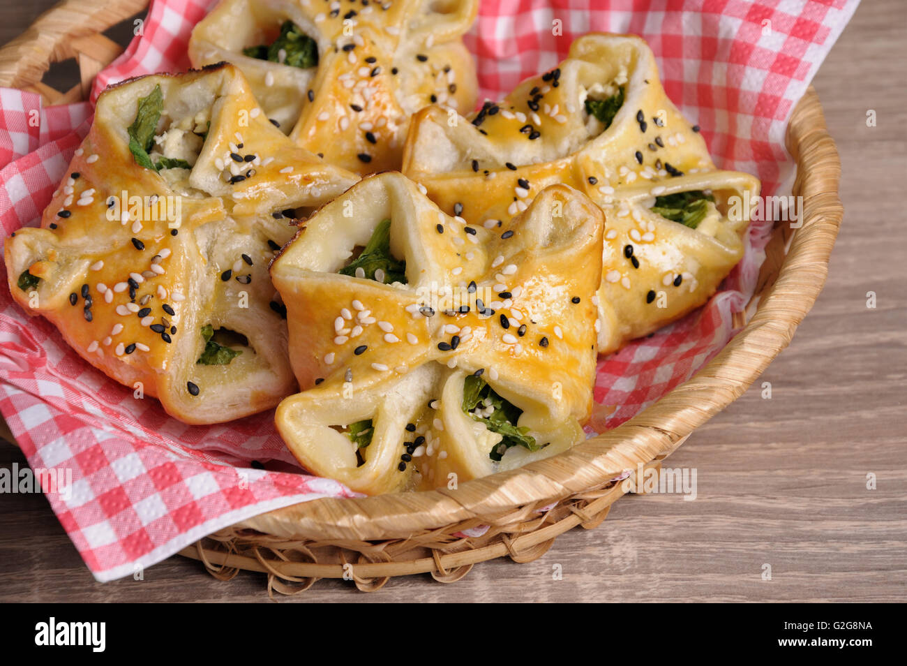 puff pastry with spinach and ricotta in a basket on table Stock Photo