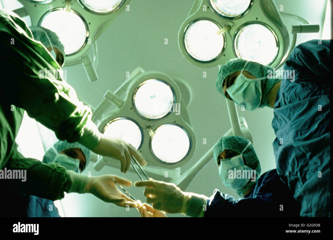 Sweden, Gothenburg. Sahlgrenska Hospital. Surgeons lean over a patient