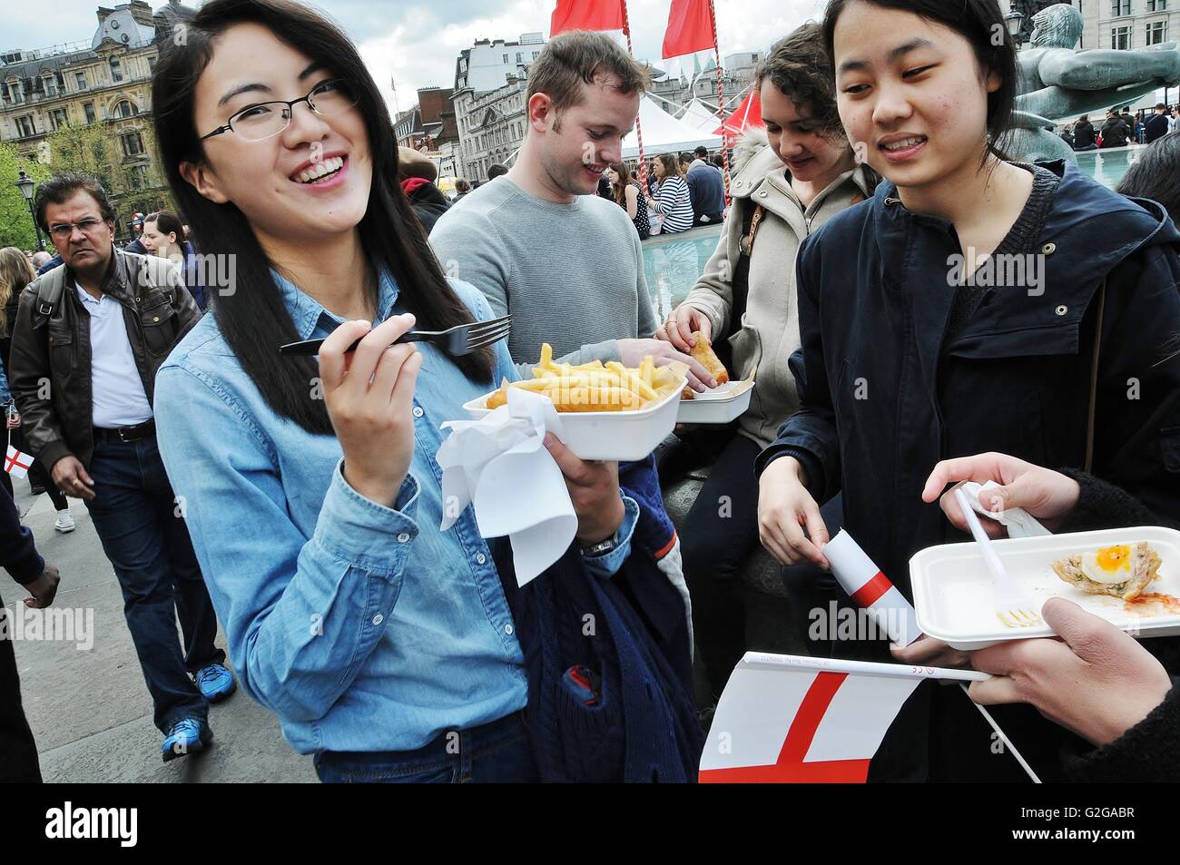 A Chinese girl enjoys fish and chips on St day, Trafalgar