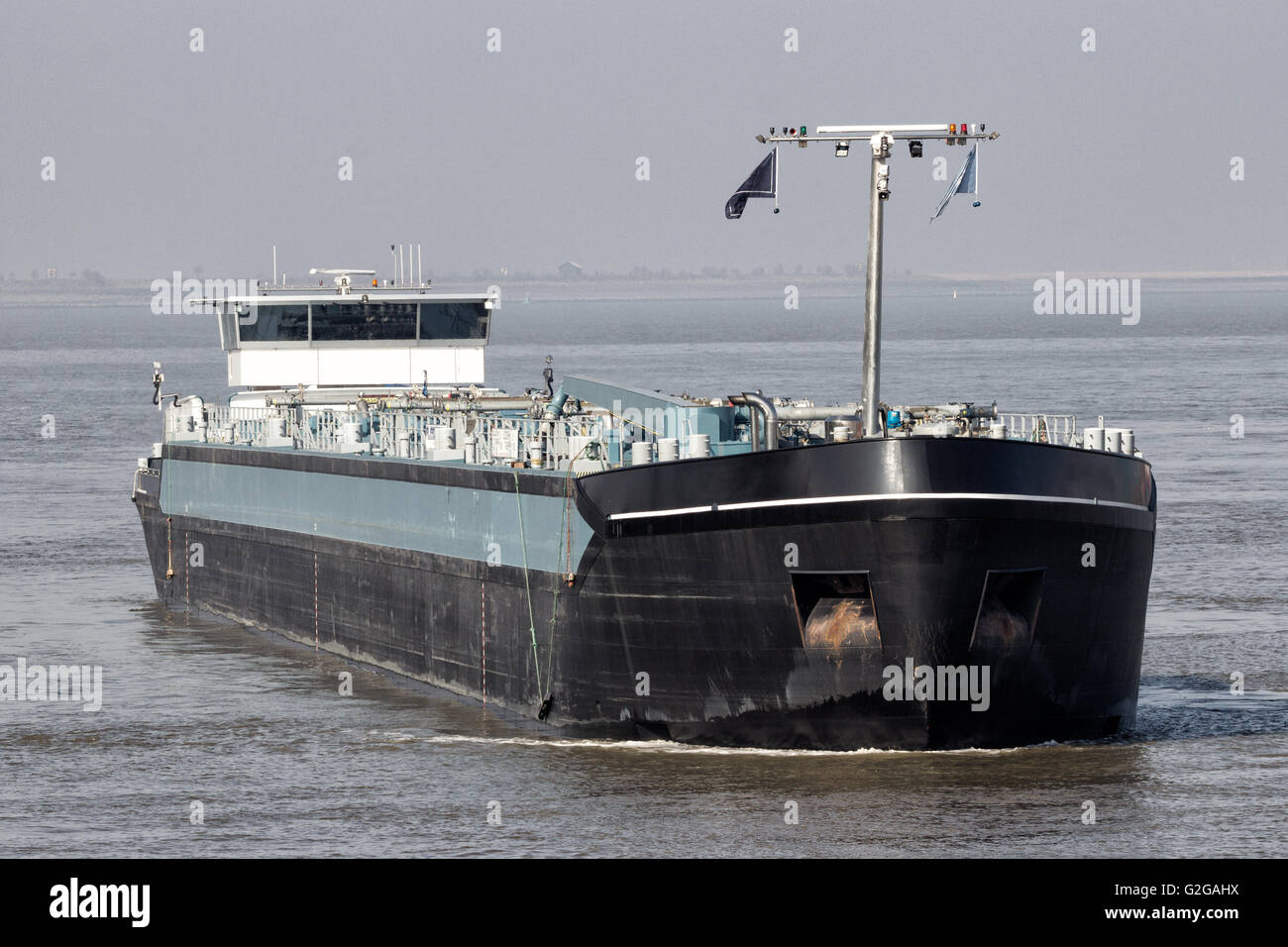 Tanker barge approaching the Port of Antwerp. Stock Photo